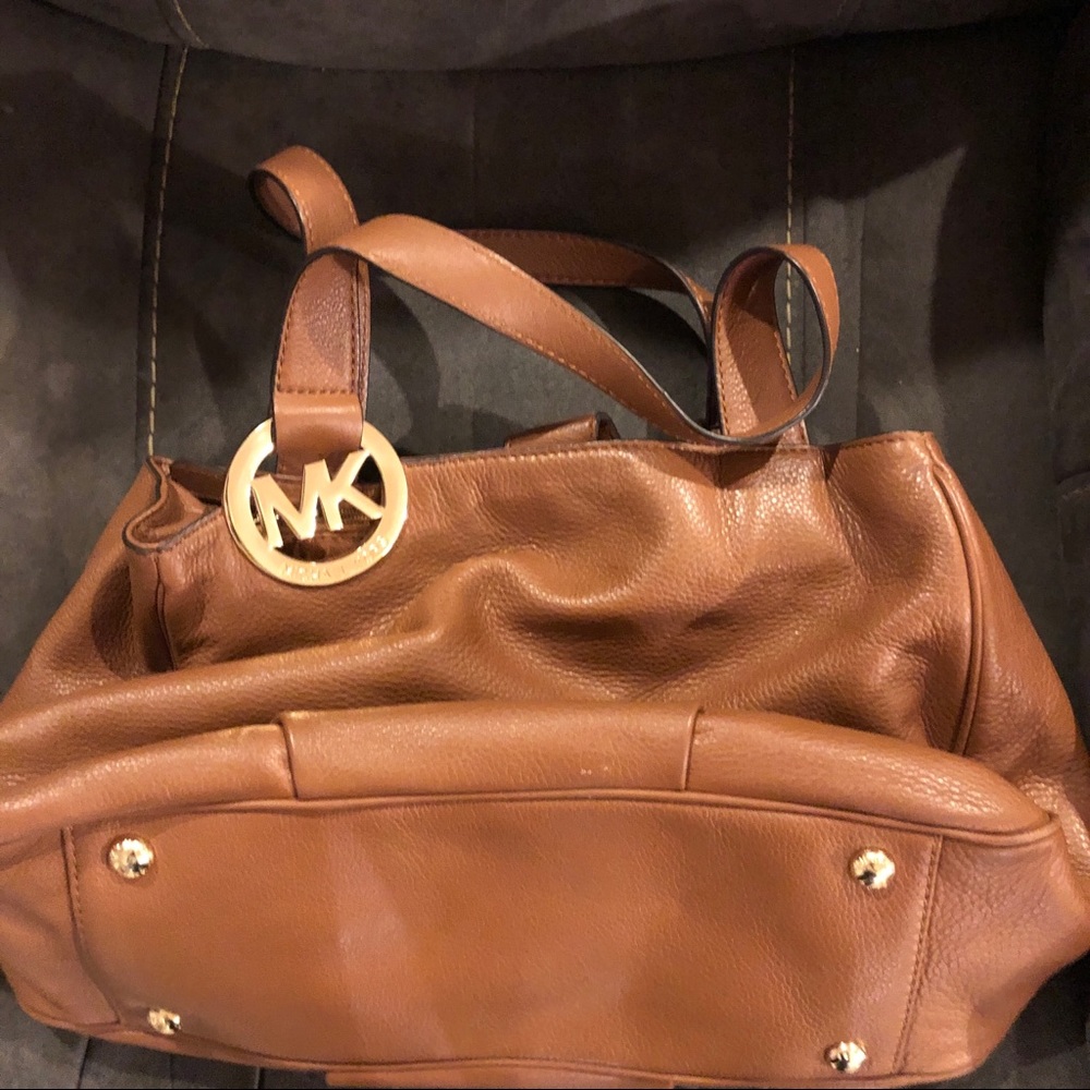 Cognac colored authentic Michael Kors Leather purse with gold hardware.